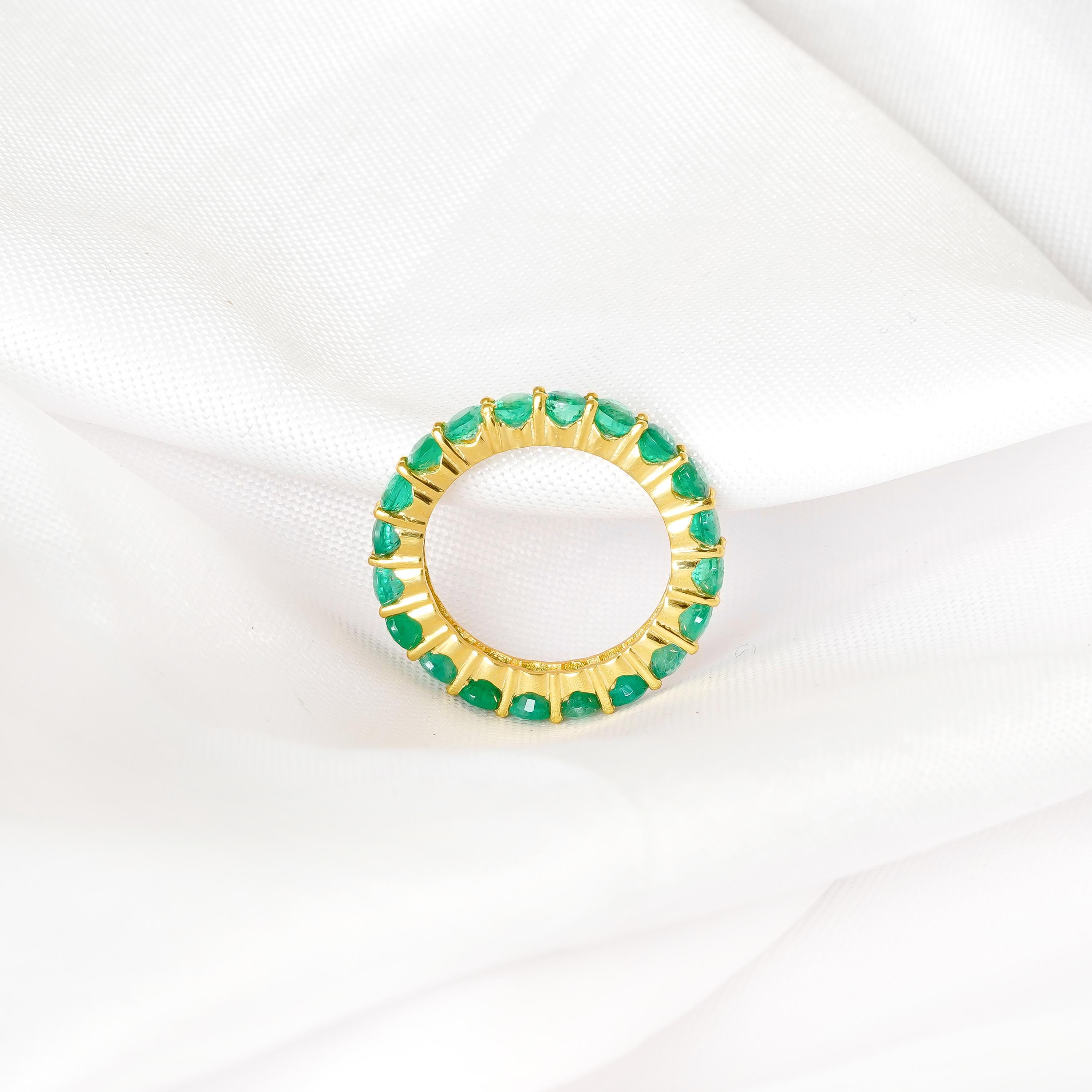 Emerald wedding band with radiant green gemstone